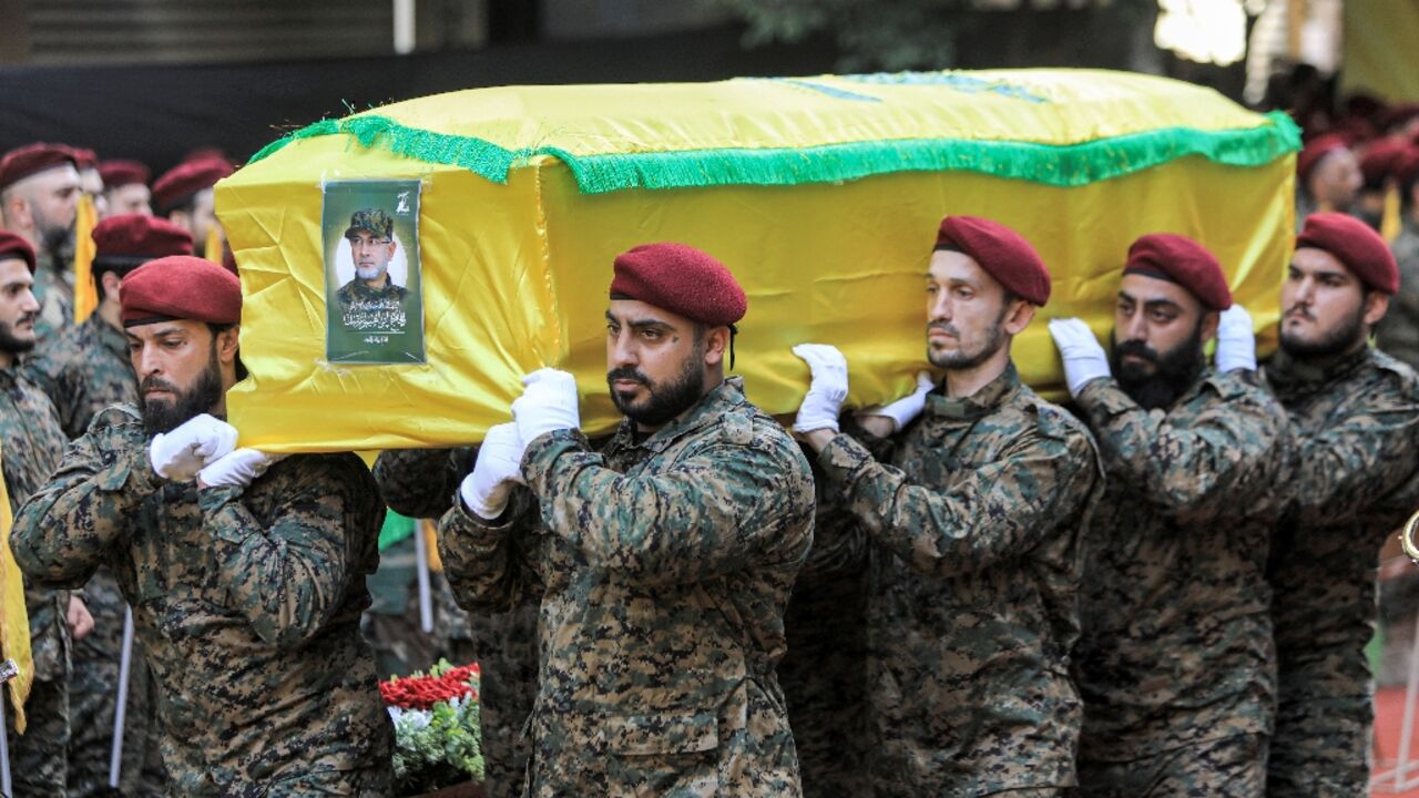 Hezbollah pall-bearers carry the coffin of Radwan Force commander Ibrahim Aqil