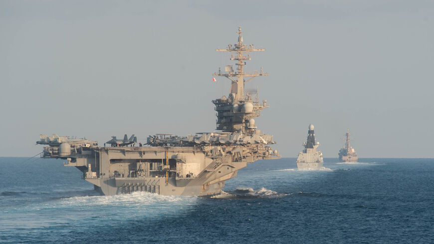 In this handout photo provided by the US Navy, the aircraft carrier USS Abraham Lincoln (L), the Royal Navy air defense destroyer HMS Defender and the guided-missile destroyer USS Farragut transit the Strait of Hormuz, Nov. 19, 2019.