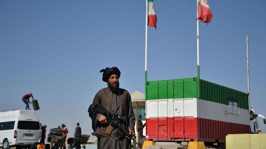 A Taliban fighter stands guard at the Islam Qala border between Iran and Afghanistan, as Iran sends tens of thousands of Afghan migrants back to Afghanistan, October 19, 2021.