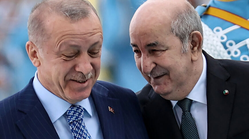 Turkish President Recep Tayyip Erdogan (L) and his Algerian counterpart Abdelmadjid Tebboune (R) speak as they review a military honour guard during the welcoming ceremony, in Ankara, on May 16, 2022. (Photo by Adem ALTAN / AFP) (Photo by ADEM ALTAN/AFP via Getty Images)