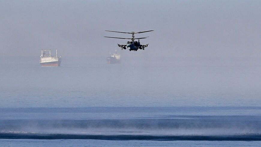 A Russian helicopter flies off the coast of the Syrian port city of Tartus, July 25, 2022.