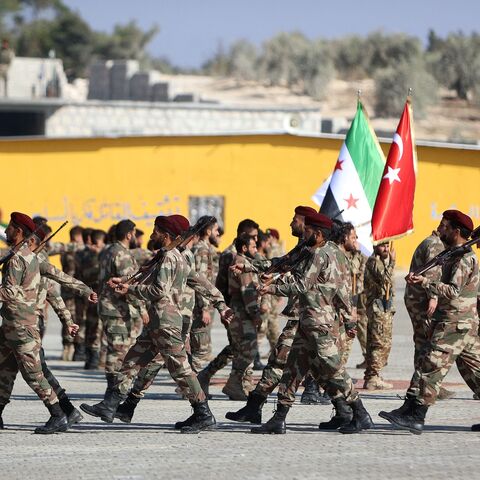 Turkish-backed Syrian fighters from the Turkish-backed 1st Corps of the Samarkand Brigade take part in a military parade in the opposition-held Afrin region of northern Syria, on Nov. 23, 2022.