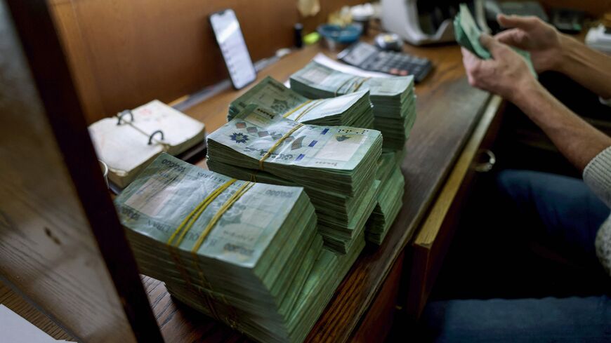 A clerk counts banknotes at a currency exchange office in Lebanon's capital Beirut, on January 20, 2023.