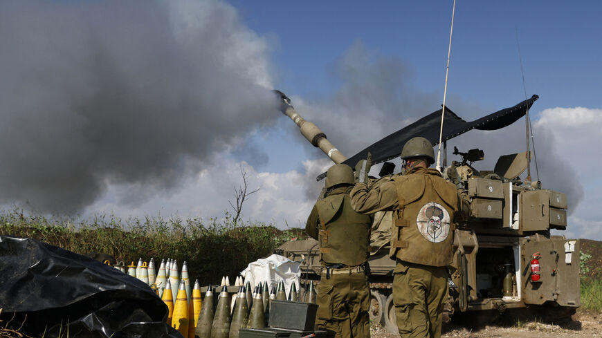 An Israeli soldier wearing a patch on the back of his flack jacket showing Lebanon's Hezbollah leader Hassan Nasrallah as a target stands in front of a self-propelled artillery howitzer, as an artillery unit shells southern Lebanon, in Upper Galilee, northern Israel, Jan. 4, 2024.