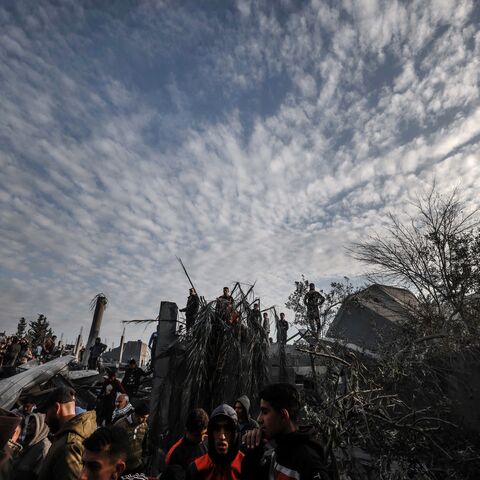 Palestinians stand amidst the rubble of a mosque and buildings which collapsed during Israeli bombardment around the town city of Rafah southern Gaza Strip on January 24, 2024, amid ongoing battles between Israel and the Palestinian militant group Hamas. (Photo by AFP) (Photo by -/AFP via Getty Images)