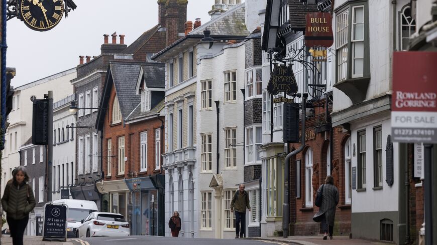 Members of the public walk along the high street on March 21, 2024, in Lewes, England. 