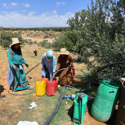 Women queue to fill containers with water from a private irrigation well provided by a farmer in Sbikha town, which has been having drinking water problems for years, near Tunisia's central city of Kairouan on June 25, 2024. Like its neighbour Algeria and large areas of the Mediterranean region, Tunisia suffers from "alert drought conditions", according to the European Drought Observatory. (Photo by FETHI BELAID / AFP) (Photo by FETHI BELAID/AFP via Getty Images)