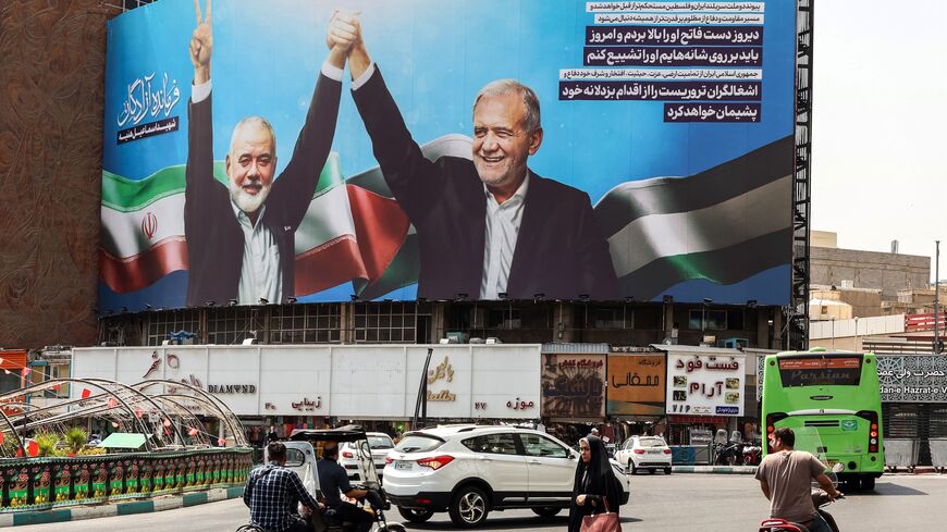 A woman walks amid vehicles next to a billboard of Iranian President Masoud Pezeshkian (R) and late Hamas leader Ismail Haniyeh at the Valise square in Tehran, on August 1, 2024.