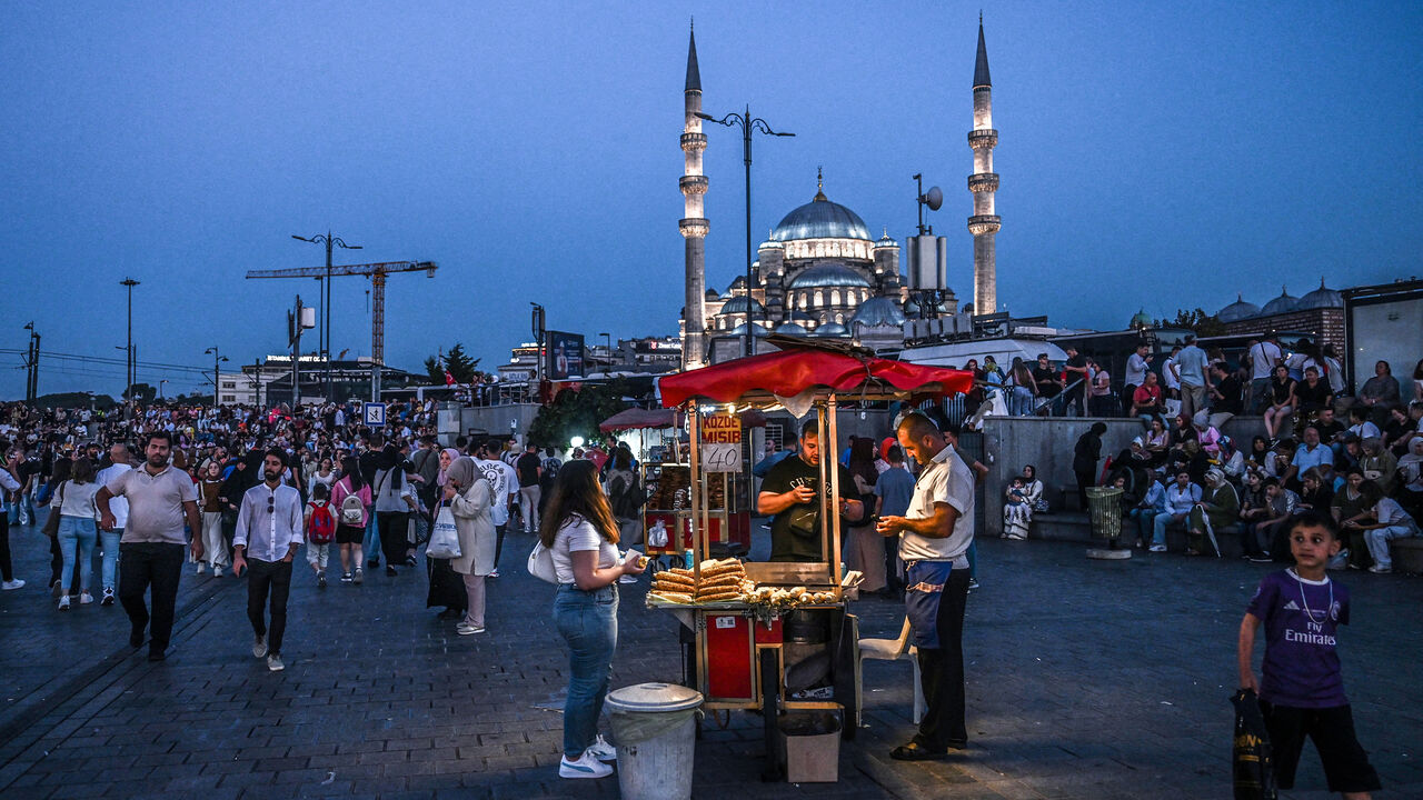 A street vendor sells corn as he waits for customers in the Eminonu district of Istanbul, Turkey, Aug. 30, 2024.