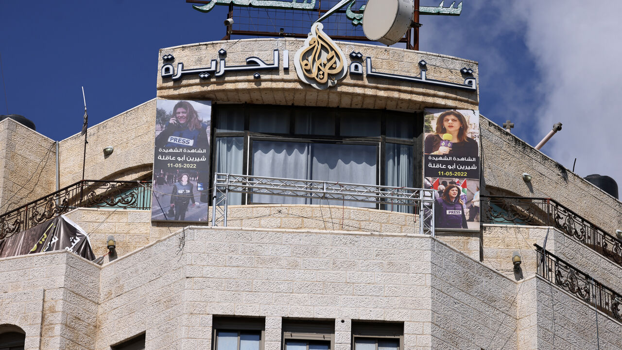 Pictures of slain al-Jazeera journalist Shireen Abu Akleh hang on the facade of the building housing the television station's office in Ramallah in the occupied West Bank, after Israel issued a 45-day closure order on September 22, 2024. Al Jazeera reported on September 22 that Israeli troops had raided its Ramallah bureau and informed journalists for the Doha-based network in the occupied West Bank to shutter operations. (Photo by JAAFAR ASHTIYEH / AFP) (Photo by JAAFAR ASHTIYEH/AFP via Getty Images)