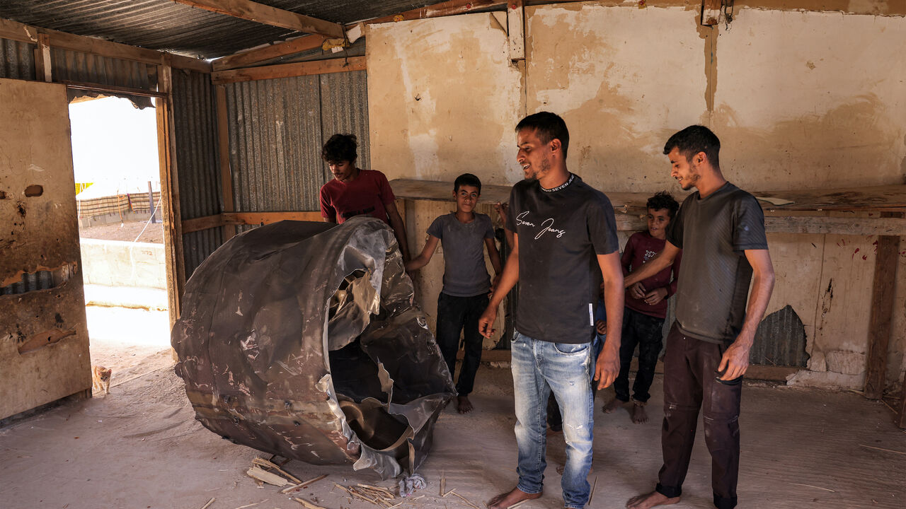 People inspect the remains of an Iranian missile that fell into the home of a Bedouin family in the Negev desert near Arad on October 2, 2024, in the aftermath of an overnight Iranian missile attack on Israel.