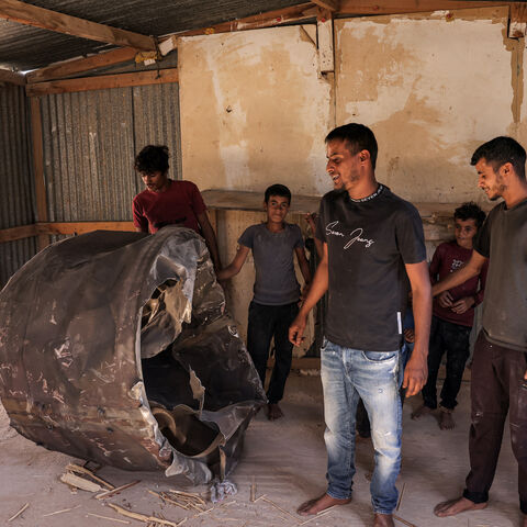 People inspect the remains of an Iranian missile that fell into the home of a Bedouin family in the Negev desert near Arad on October 2, 2024, in the aftermath of an overnight Iranian missile attack on Israel.