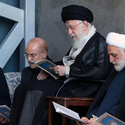 In this handout image provided by the Iranian Leader's Press Office, Iranian Supreme leader Ali Khamenei (C) is seen alongside Iran's President Masoud Pezeshkian (L), Parliament Speaker Mohammad Bagher Ghalibaf (2L), Judiciary Chief Mohsen Ejeie (2R) and Hezbollah representative in Iran Abdallah Safieddine reading the Koran during the Friday prayer ceremony on October 04, 2024 in Tehran, Iran.