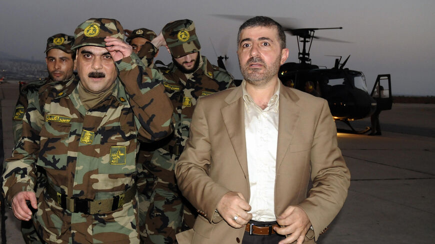 Freed Lebanese prisoner Samir Kantar (L), wearing Hezbollah military fatigues, arrives with his freed comrades (back) and Wafiq Safa (R), Hezbollah coordinator for the prisoner swap with Israel, to the airport in Beirut on July 16, 2008. Five Lebanese prisoners freed by the Israeli authorities arrived in Lebanon today, hours after Hezbollah handed over the bodies of two Israeli soldiers seized by its guerrillas two years ago. Among those freed in a prisoner swap greeted with triumph in Lebanon but anguish i