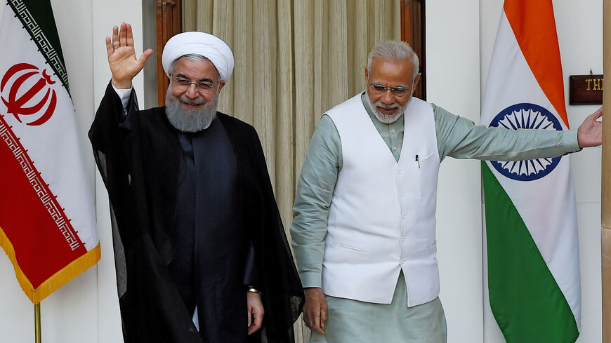 Iran's former President Hassan Rouhani (L) waves to the media as India's Prime Minister Narendra Modi looks on before a meeting at Hyderabad house, New Delhi, India, Feb. 17, 2018.