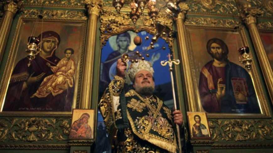 A Greek Orthodox priest attends Christmas services at the Saint Porfirios church in Gaza City January 7, 2012. REUTERS/Mohammed Salem (GAZA - Tags: RELIGION) - RTR2VZBO