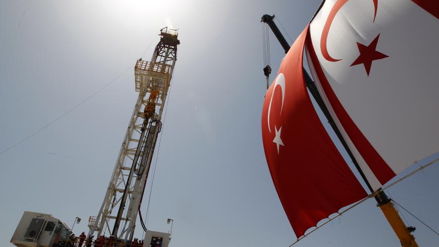 Turkish and Turkish Cypriot flags wave next to a drilling tower 25 km (16 miles) from Famagusta April 26, 2012. Turkish Cypriot Leader Dervis Eroglu and Turkey's Energy Minister Taner Yildiz attended a ceremony marking the start of joint gas and oil exploration works in northern Cyprus between Turkey's state-owned energy company TPAO and the Turkish-Cypriot administration. REUTERS/Umit Bektas (CYPRUS - Tags: POLITICS ENERGY BUSINESS) - GM1E84Q1HIQ01