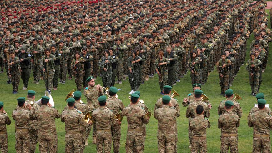 Kurdish fighters from the People's Protection Units (YPG) take part in a military parade as they celebrate victory over the Islamic state, in Qamishli, Syria March 28, 2019. REUTERS/Rodi Said - RC1E6CB8BBB0