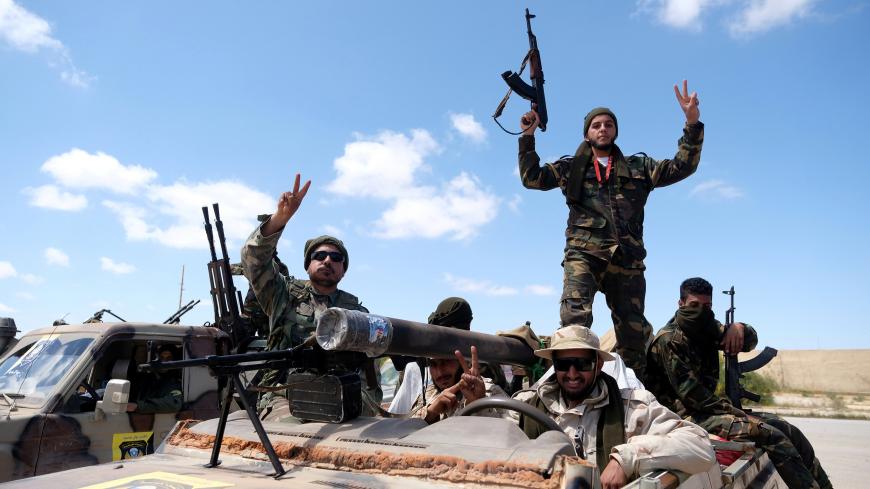 Libyan National Army (LNA) members, commanded by Khalifa Haftar, pose for a picture as they head out of Benghazi to reinforce the troops advancing to Tripoli, in Benghazi, Libya April 7, 2019. REUTERS/Esam Omran Al-Fetori - RC1AEB991490