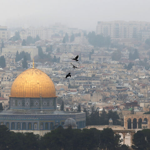 Birds fly on a foggy day near the Dome of the Rock, located in Jerusalem's Old City on the compound known to Muslims as Noble Sanctuary and to Jews as Temple Mount, Jerusalem, January 2, 2018. REUTERS/Ammar Awad - RC1FAC4E2C00